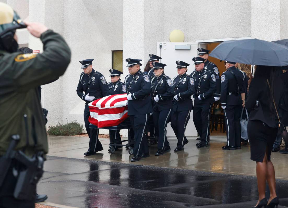 Honor Guard members carry the casket of slain North Las Vegas police officer Jason Roscow, 46, ...