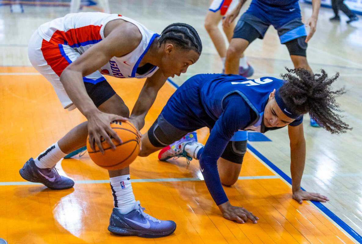 Bishop Gorman's Kameron Cooper (14) grabs a loose ball from Centennial's Jayonni Durrough (25) ...
