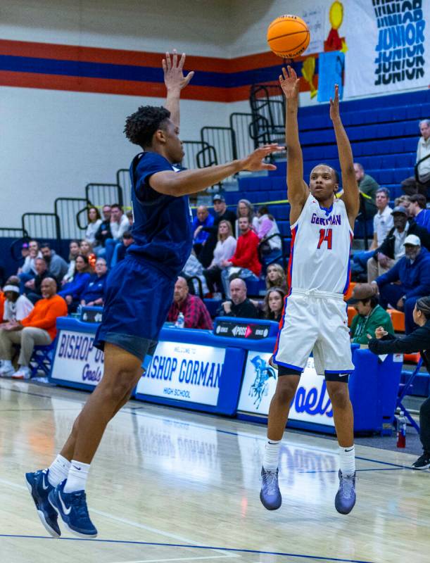Bishop Gorman's Kameron Cooper (14) shoots over Centennial's Bryce Iwuoha (44) during the first ...