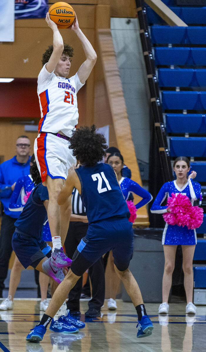 Bishop Gorman's Chris Baudreau (21) grabs a rebound over Centennial's Jaylen Kelly (21) during ...