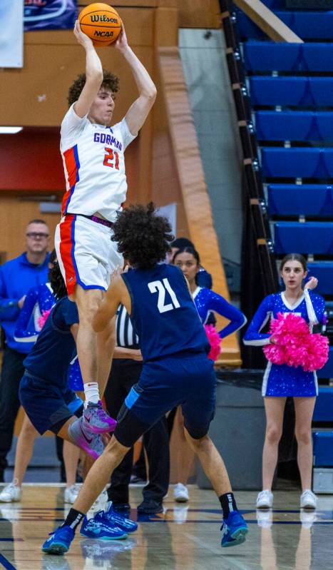Bishop Gorman's Chris Baudreau (21) grabs a rebound over Centennial's Jaylen Kelly (21) during ...