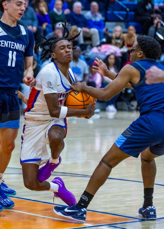 Bishop Gorman's Nick Jefferson (10) is fouled on a drive by Centennial's LaDainian Ivery (1) du ...