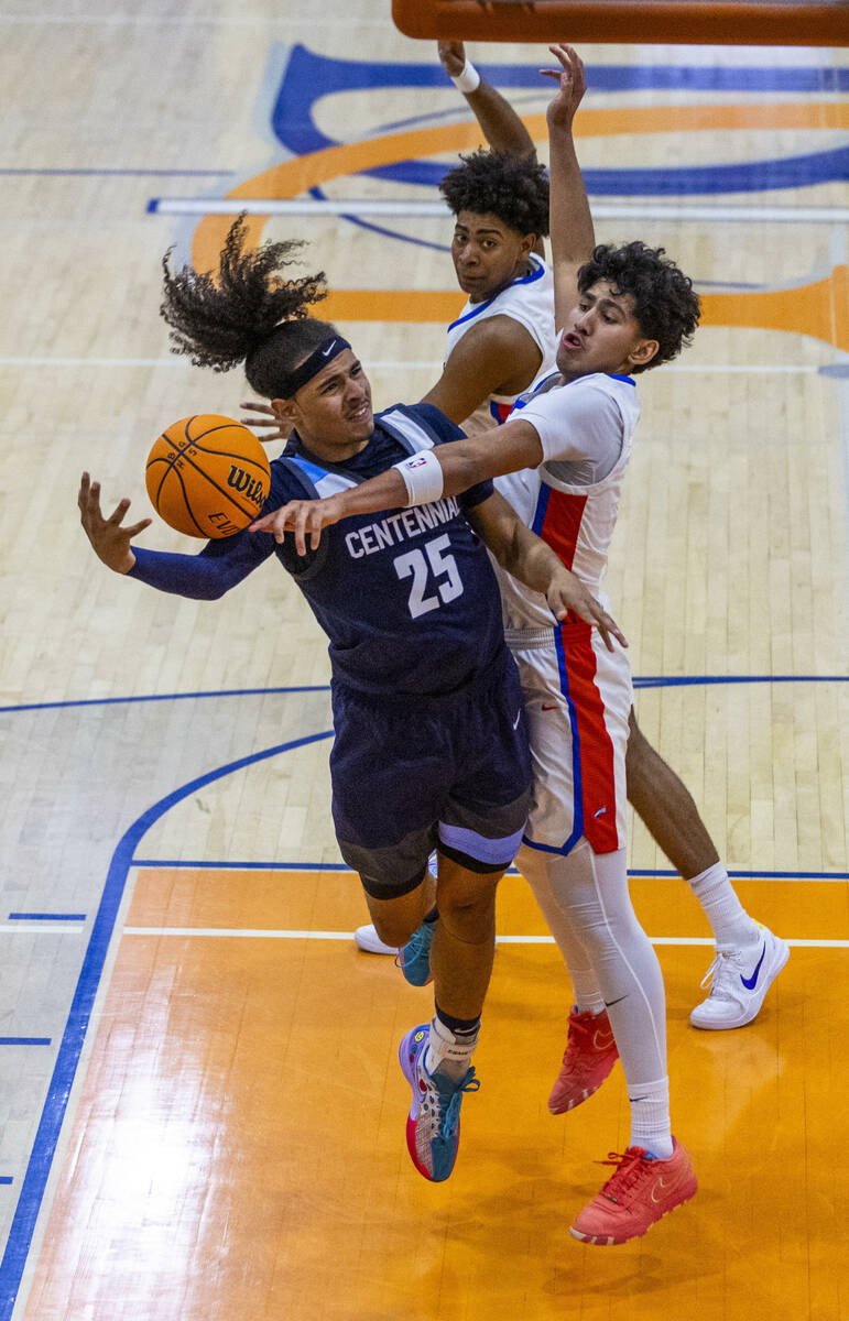 Centennial's Jayonni Durrough (25) has the ball poked away by Bishop Gorman's Kingston Carmona ...