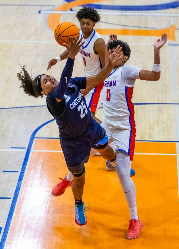 Centennial's Jayonni Durrough (25) attempts to shoot after contact with Bishop Gorman's Kingsto ...