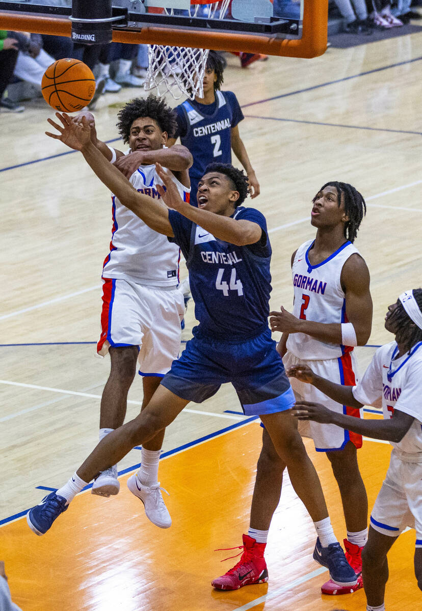 Centennial's Bryce Iwuoha (44) battles for a loose ball with Bishop Gorman's Trey McKinney (4) ...
