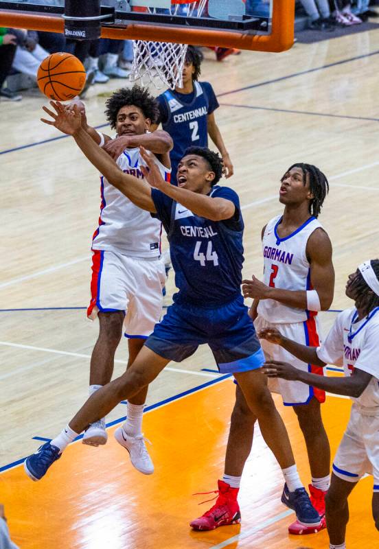 Centennial's Bryce Iwuoha (44) battles for a loose ball with Bishop Gorman's Trey McKinney (4) ...