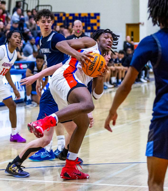 Bishop Gorman's Jett Washington (2) pulls down a rebound over Centennial's Jaxon Price (11) dur ...
