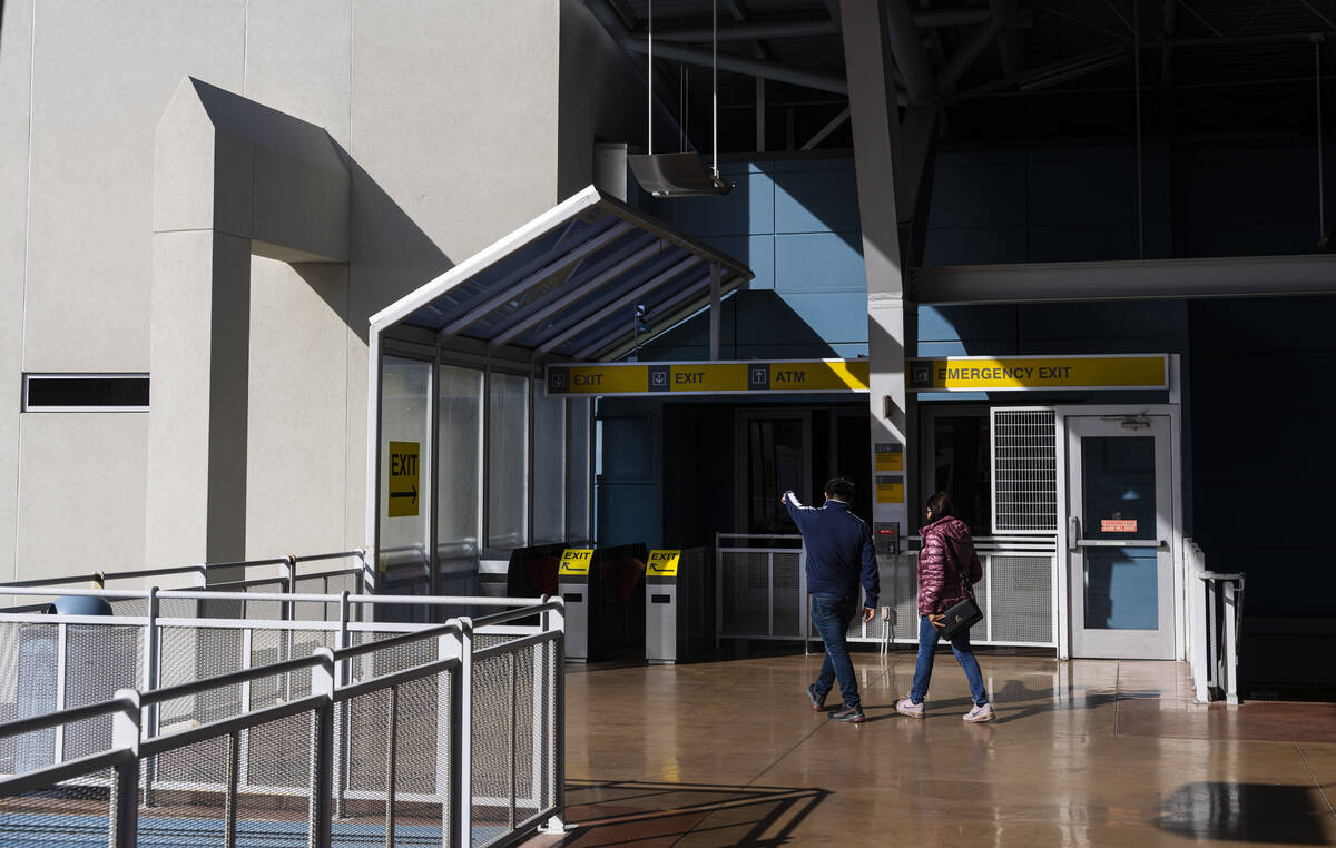 Las Vegas Monorail passengers head towards an exit at the Harrah’s & The Linq statio ...