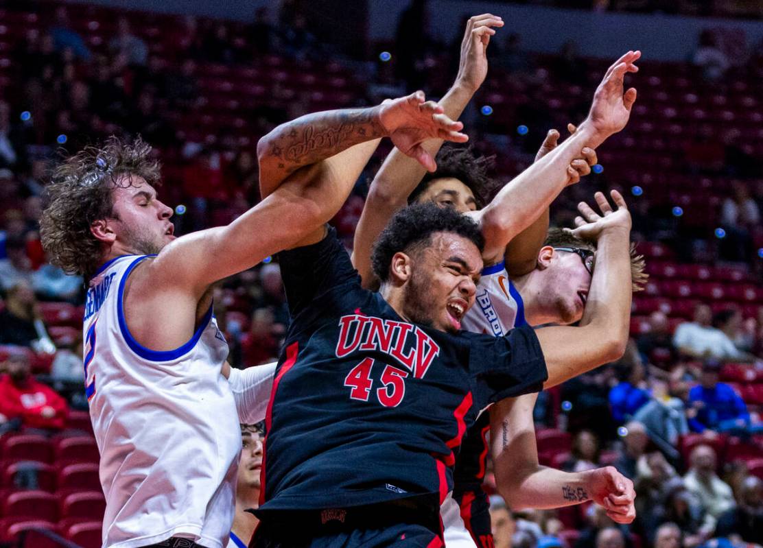 UNLV forward Jeremiah Cherry (45) is mugged by Boise State Broncos forward Tyson Degenhart (2) ...