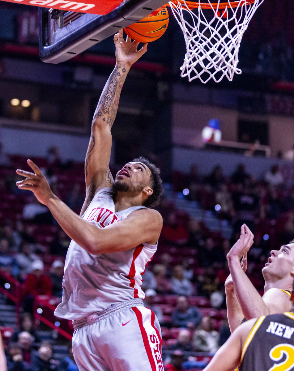 UNLV forward Jeremiah Cherry (45) lays the ball in against the Wyoming Cowboys during the first ...