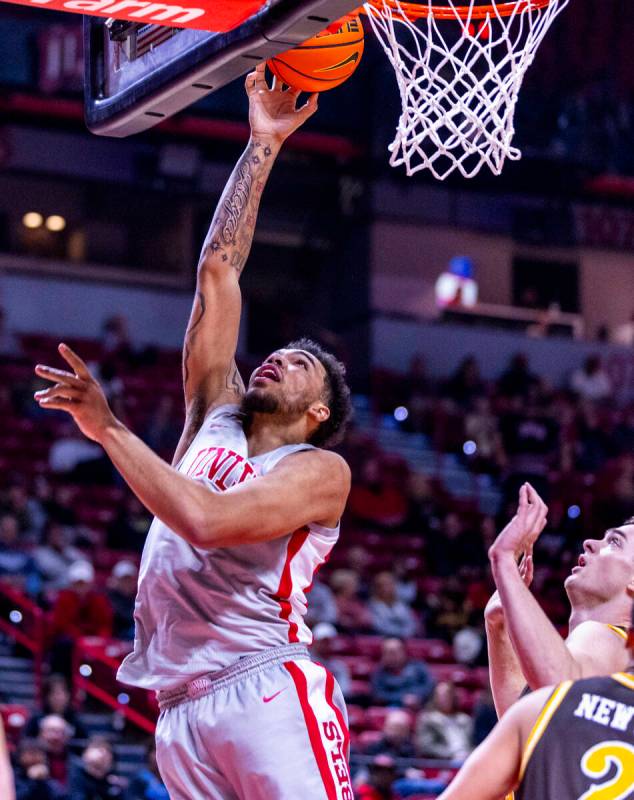 UNLV forward Jeremiah Cherry (45) lays the ball in against the Wyoming Cowboys during the first ...