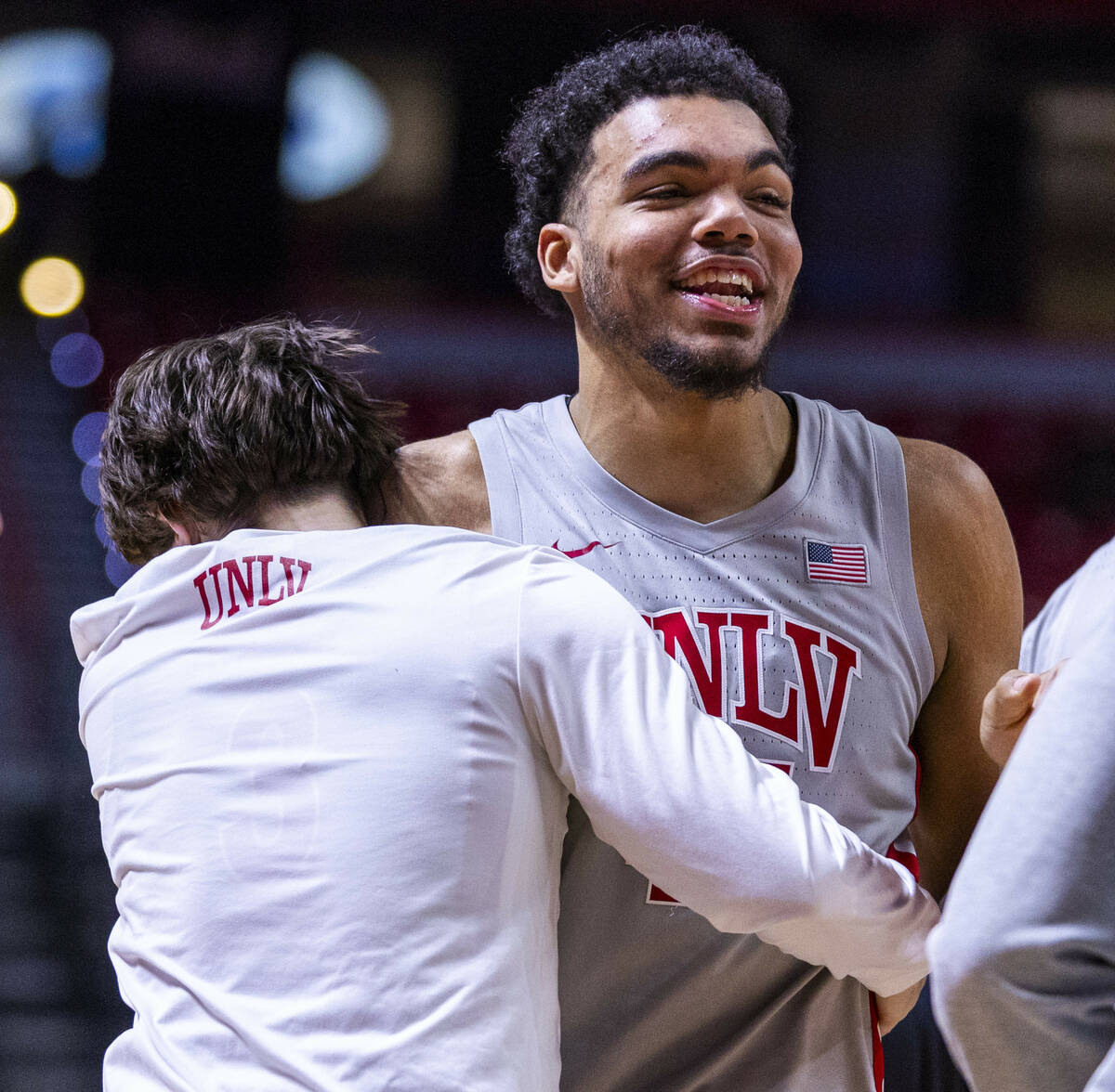 UNLV forward Jeremiah Cherry (45) and a teammate share a laugh in a time out against the Wyomin ...
