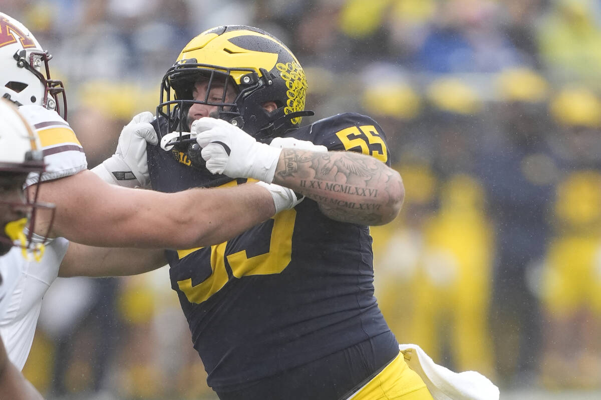 Michigan defensive lineman Mason Graham (55) plays during the first half of an NCAA college foo ...