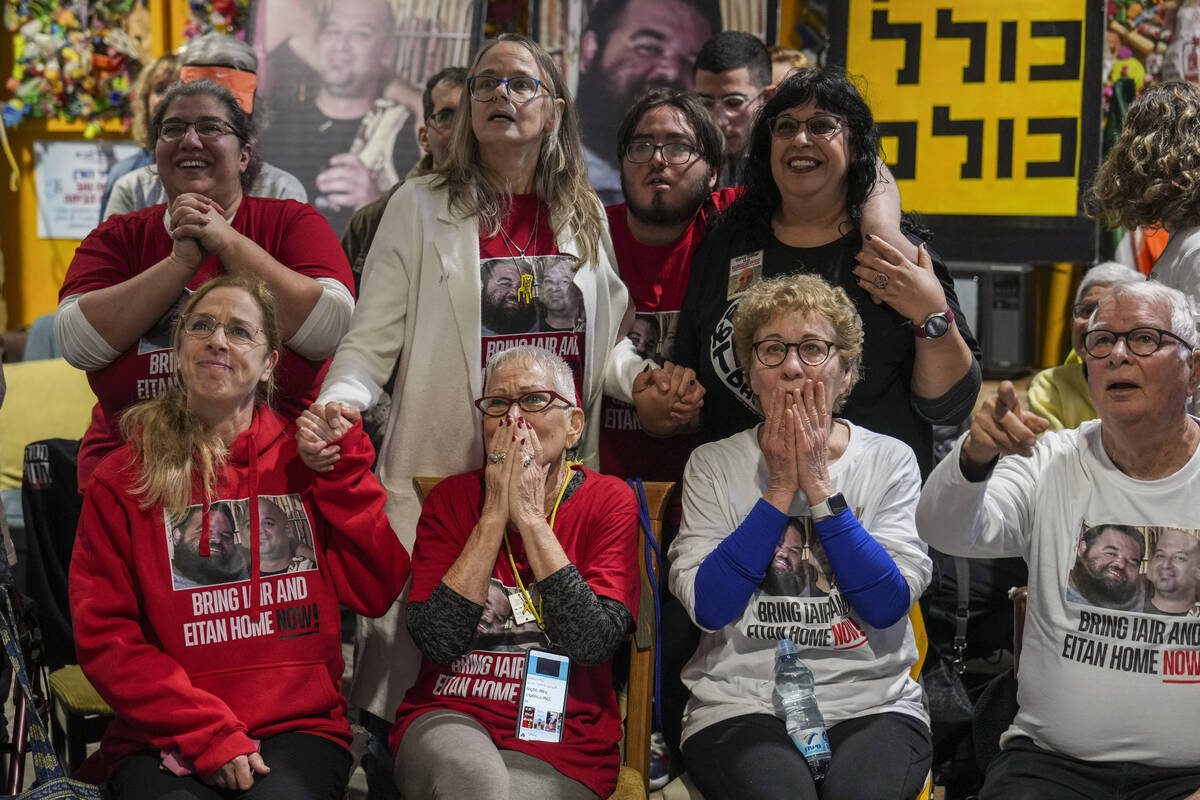 Friends of Iair Horn watch a live Gaza broadcast of his release from Hamas captivity during a g ...