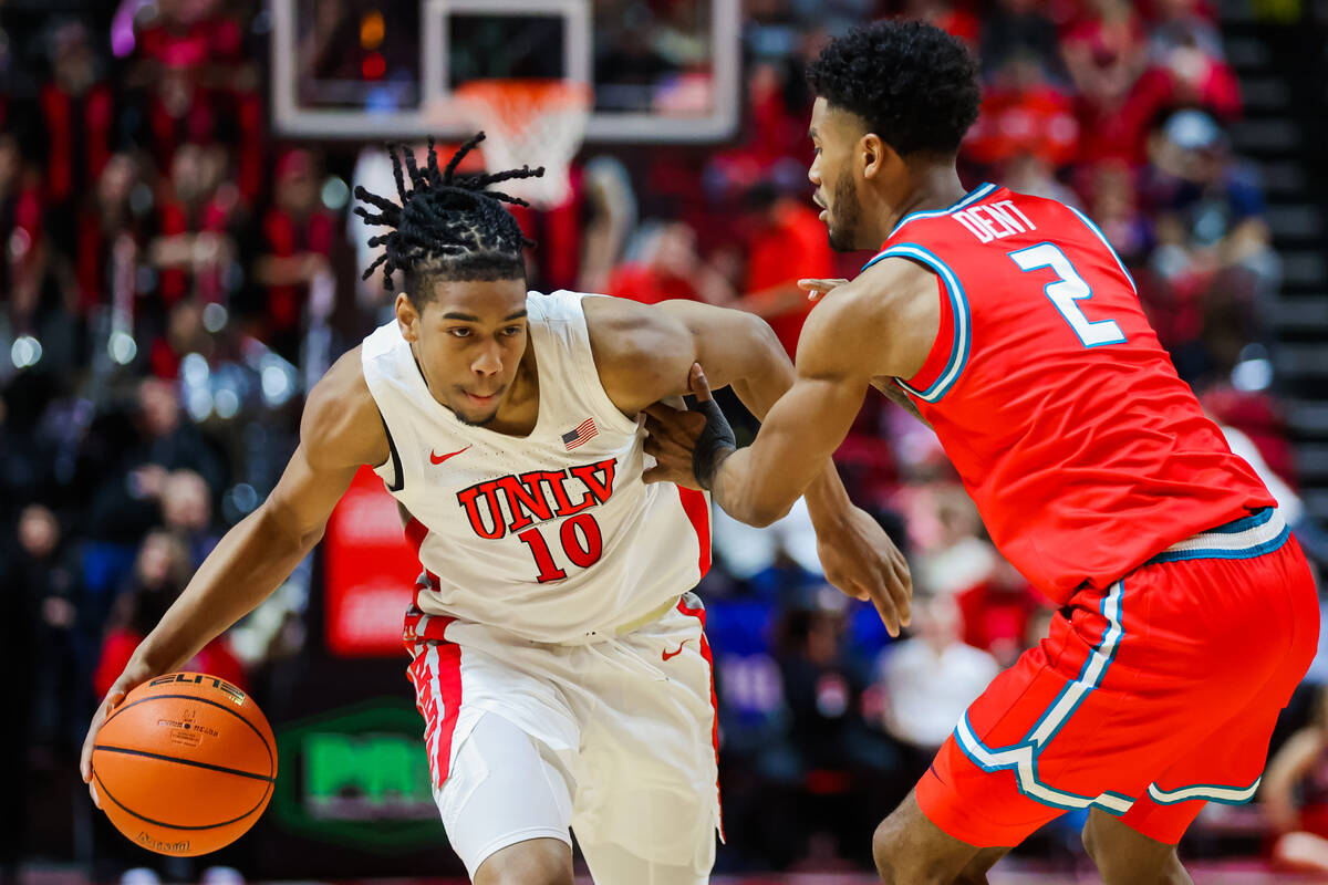 Rebels guard Jaden Henley (10) drives past New Mexico Lobos guard Donovan Dent (2) during an NC ...