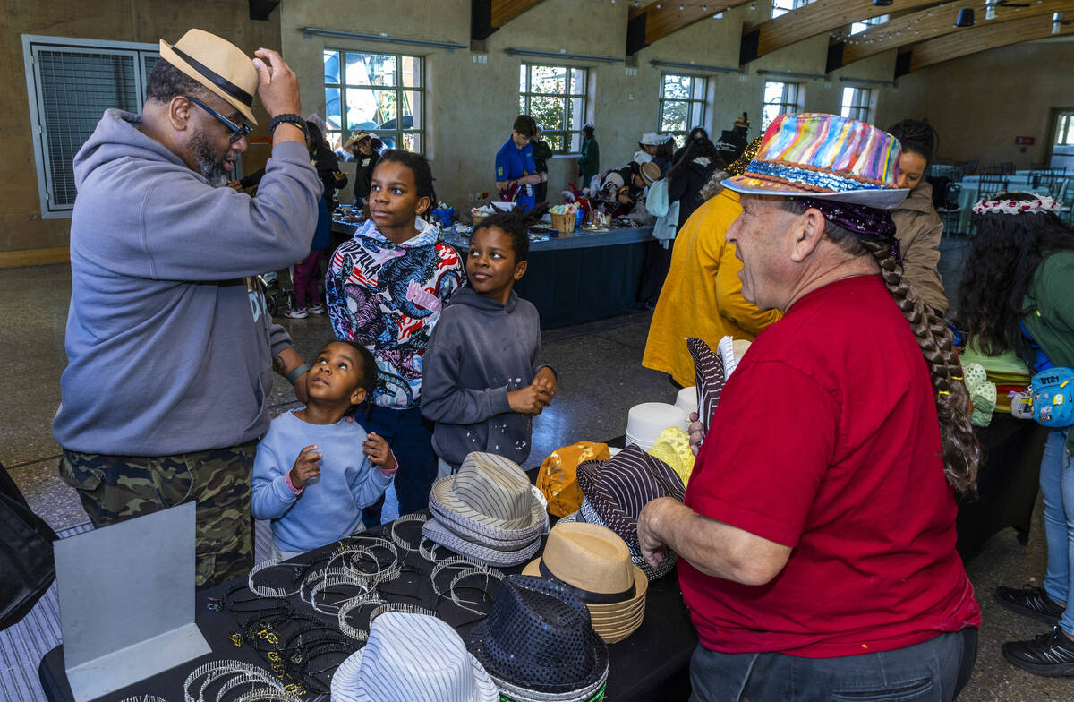 Attendees select hats to decorate in the "Make your own Kufi hat" room during the Bla ...