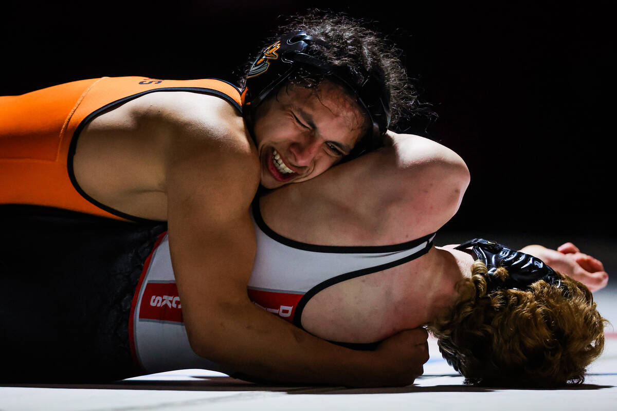 Chaparral wrestler Vicente Tizoc, top, pins down Desert Oasis wrestler Chance Mannino during th ...