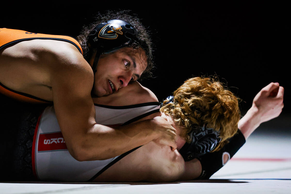 Chaparral wrestler Vicente Tizoc, top, pins down Desert Oasis wrestler Chance Mannino during th ...