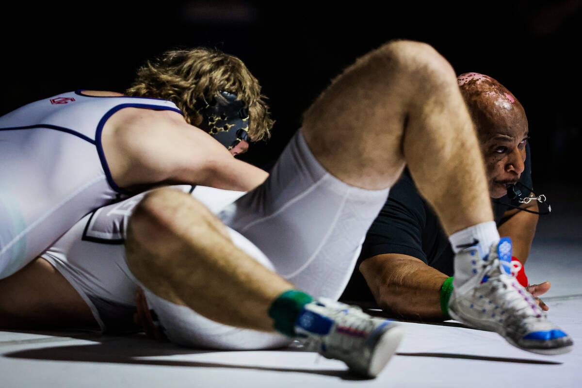 A referee whistles during the 4A state wrestling meet at Western High School Saturday, Feb. 15, ...