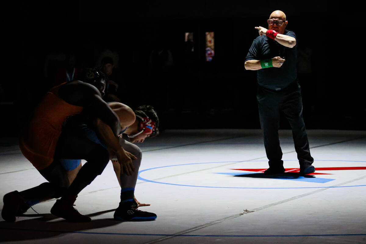 A referee signals during the 4A state wrestling meet at Western High School Saturday, Feb. 15, ...