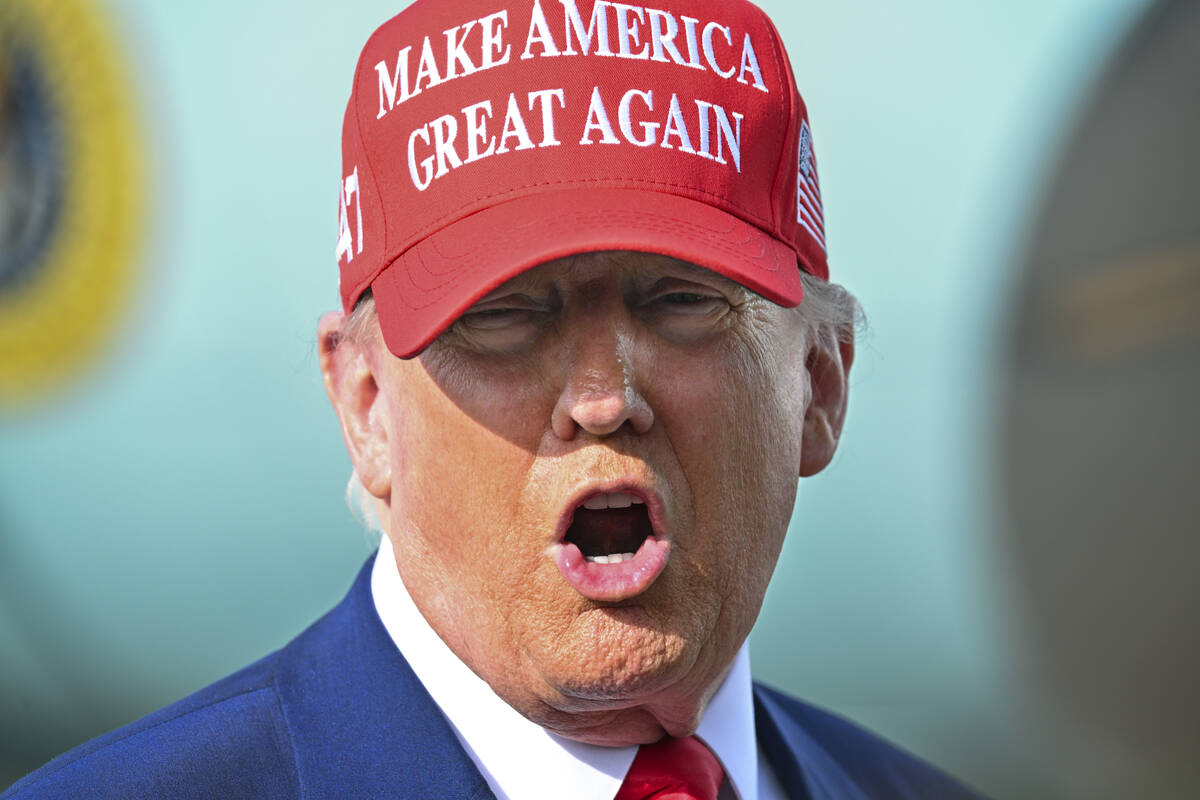 President Donald Trump speaks to reporters after landing at Palm Beach International Airport in ...