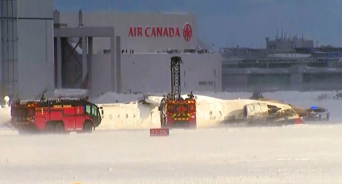 This image taken from video provided by CTV shows emergency crews responding at Toronto Pearson ...