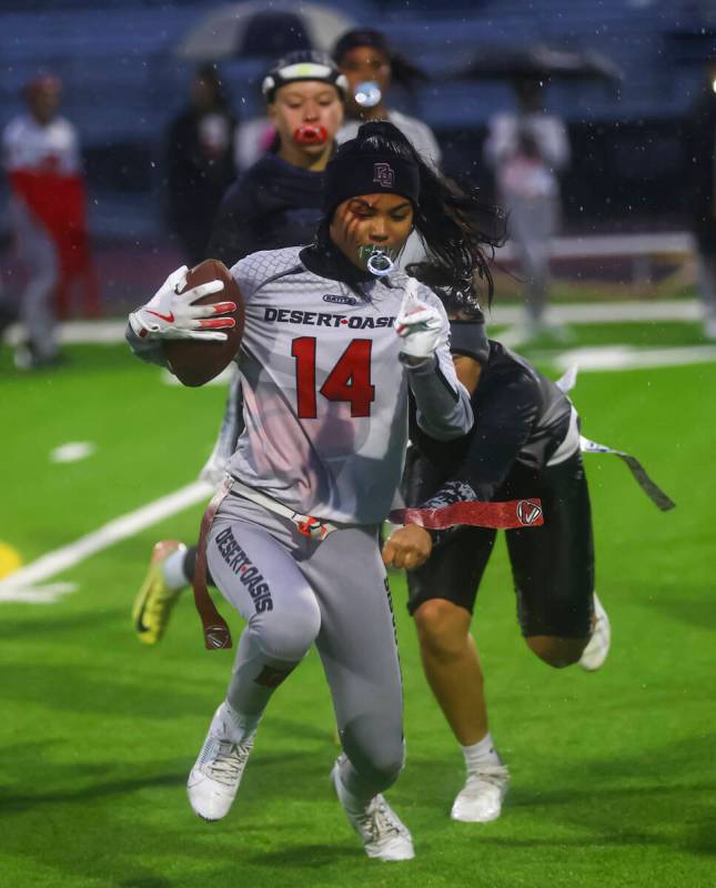 Desert Oasis' Allie Peralta runs the ball under pressure from Shadow Ridge during a 5A state se ...