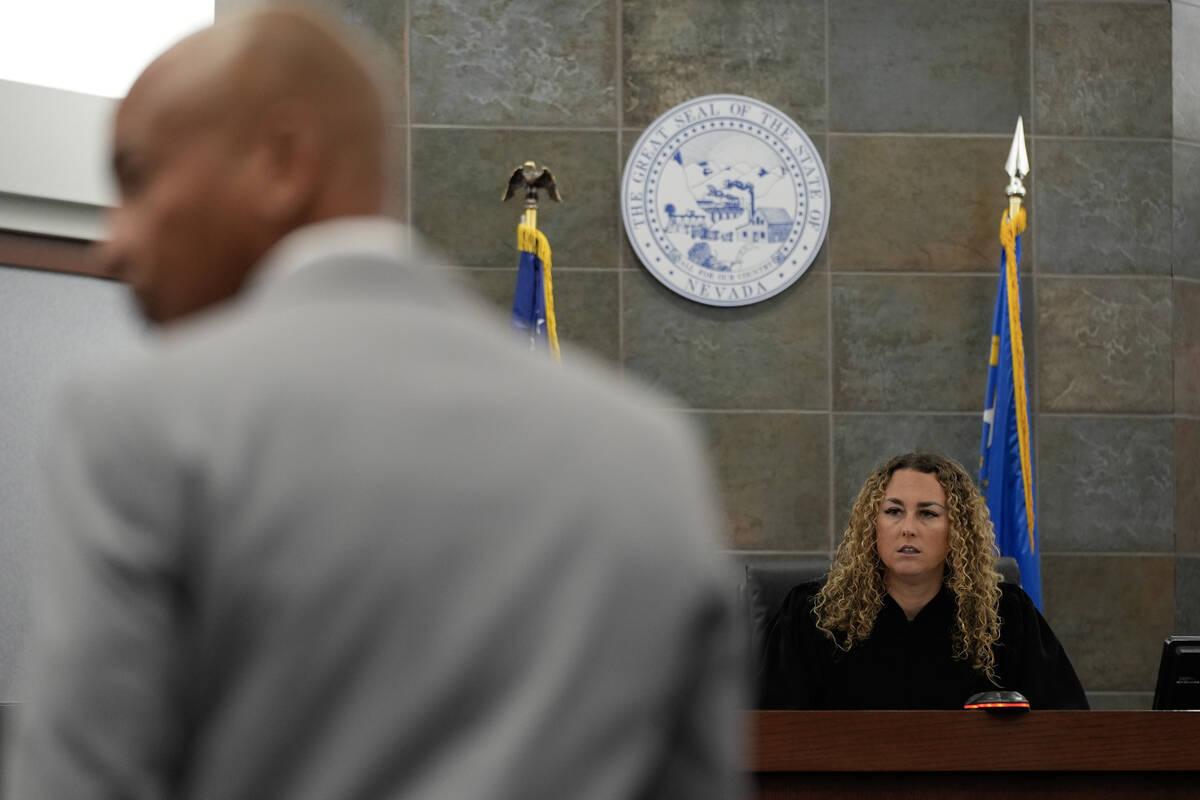 Carl E.G. Arnold, left, attorney for Duane "Keffe D" Davis, listens with District Judge Carli K ...