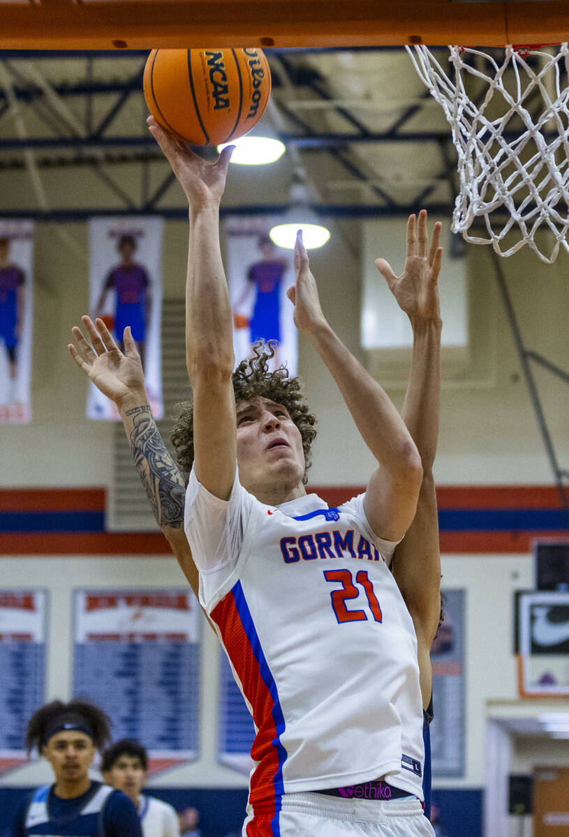 Bishop Gorman's Chris Baudreau (21) posts up for a basket over Centennial during the first half ...