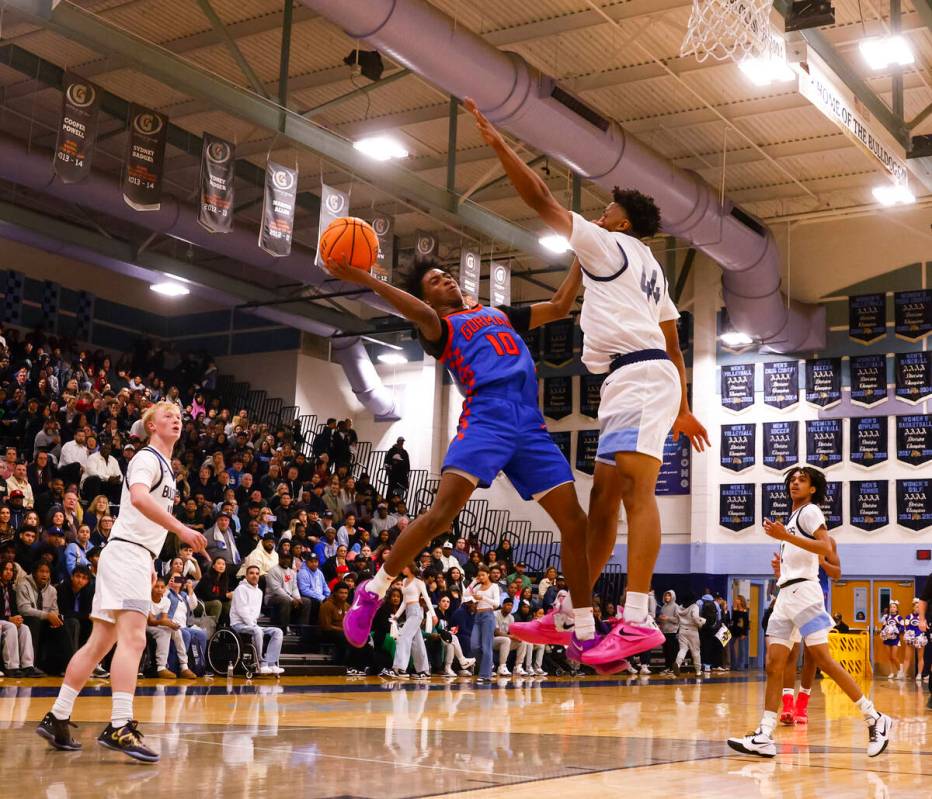 Bishop Gorman guard Nick Jefferson (10) tries to shoot around Centennial's Bryce Iwuoha (44) du ...