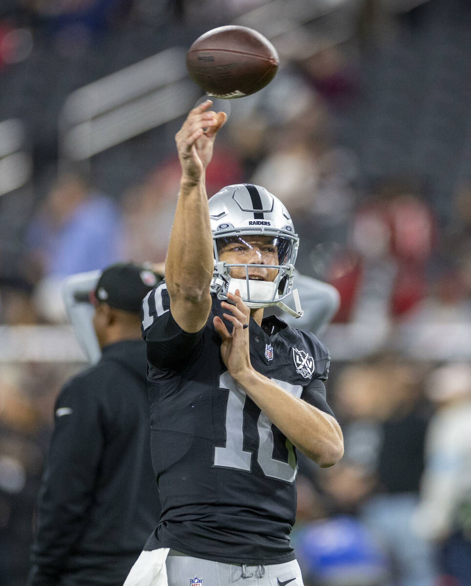 Raiders quarterback Desmond Ridder (10) tosses a pass during warm ups before the first half of ...