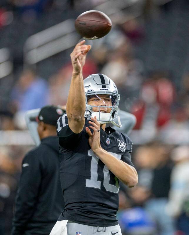 Raiders quarterback Desmond Ridder (10) tosses a pass during warm ups before the first half of ...