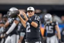 Raiders quarterback Aidan O'Connell (12) warms up on the sideline during the first half of an N ...