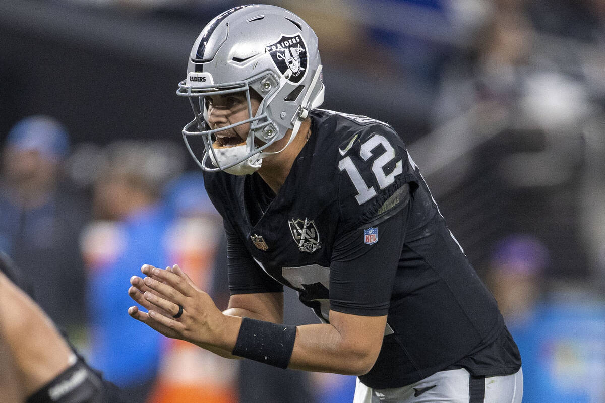 Raiders quarterback Aidan O'Connell (12) calls for the snap during the second half of an NFL ga ...