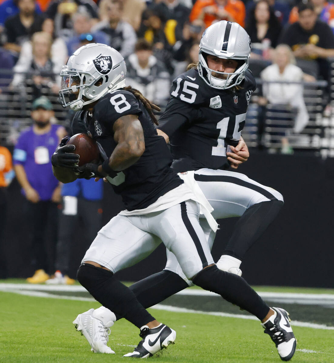 Raiders quarterback Gardner Minshew (15) hands off to running back Ameer Abdullah (8) during th ...