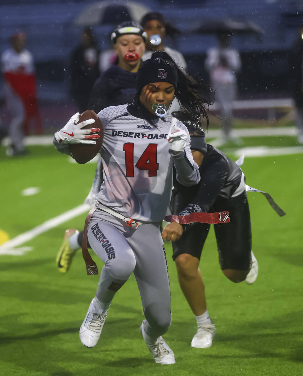 Desert Oasis' Allie Peralta runs the ball under pressure from Shadow Ridge during a 5A state se ...