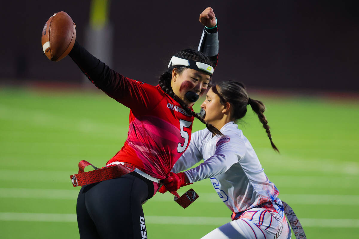 Desert Oasis quarterback Akemi Higa (5) gets her flag yanked during a flag football game betwee ...