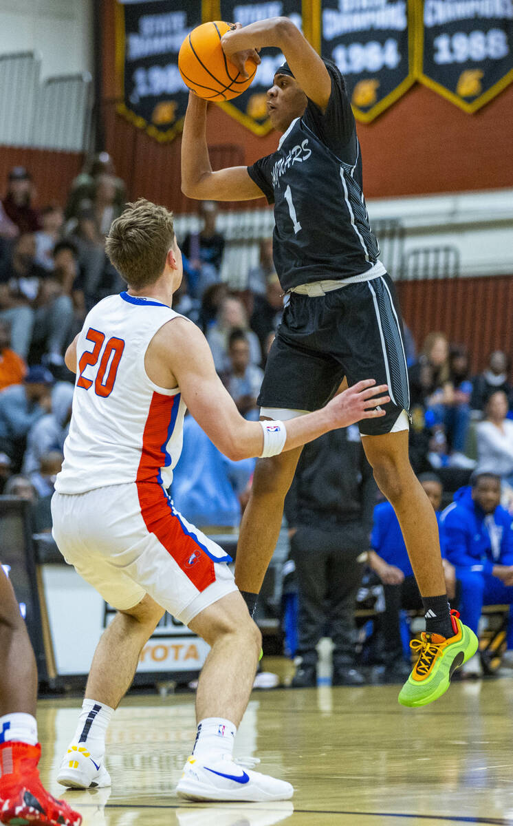 Desert Pines guard Jaden Redding (1) looks to pass over Bishop Gorman guard Ilan Nikolov (20) ...
