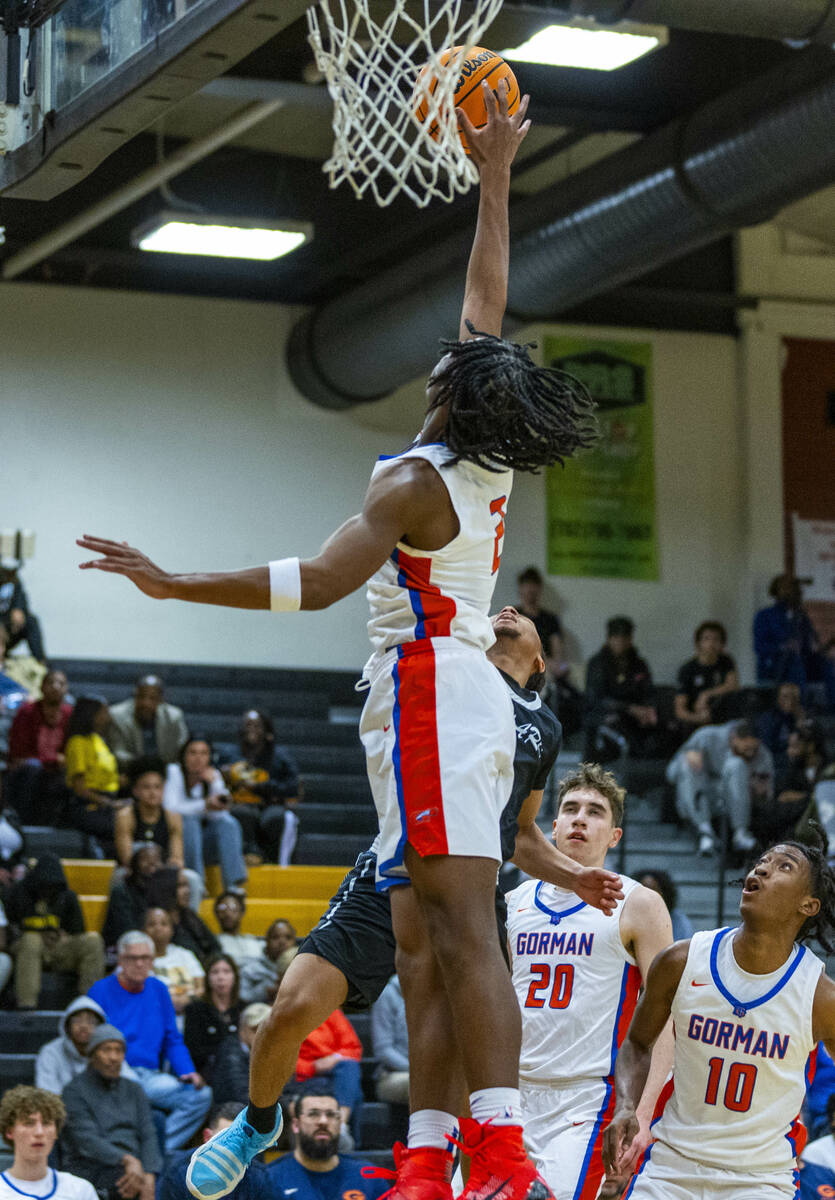 Bishop Gorman forward Jett Washington (2) blocks a Desert Pines shot attempt during the first h ...