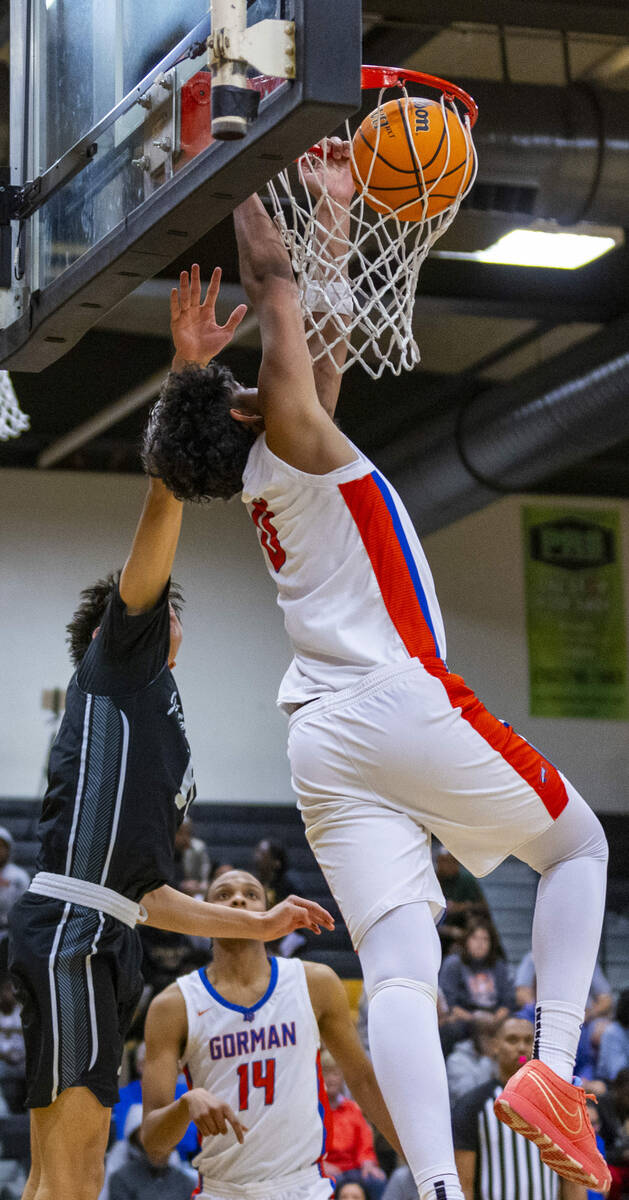 Bishop Gorman forward Kingston Carmona (0) jams the ball over Desert Pines (15) during the seco ...
