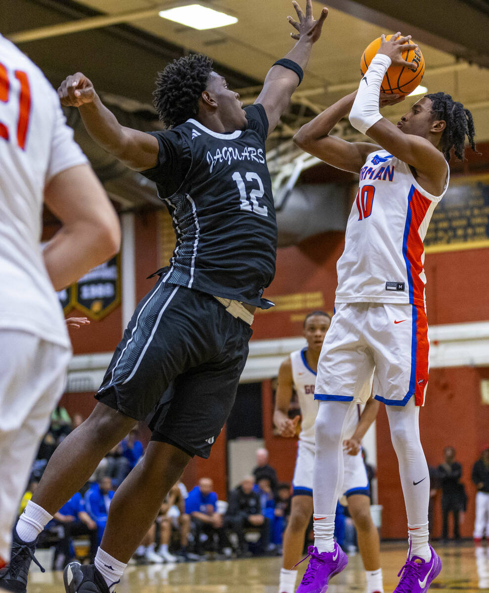 Desert Pines forward Mike Taylor (12) arrives late to block shot by Bishop Gorman guard Nick Je ...