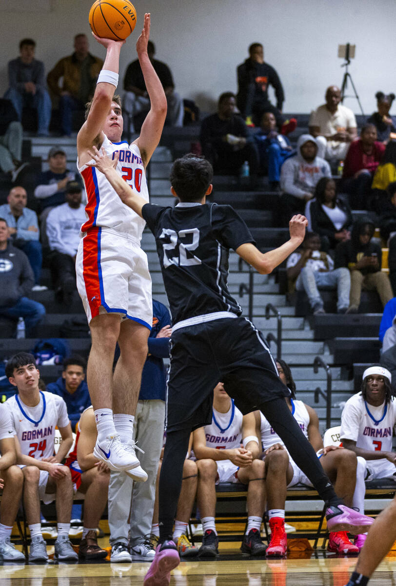 Bishop Gorman guard Ilan Nikolov (20) shoots a three-point basket over Desert Pines guard Aaron ...