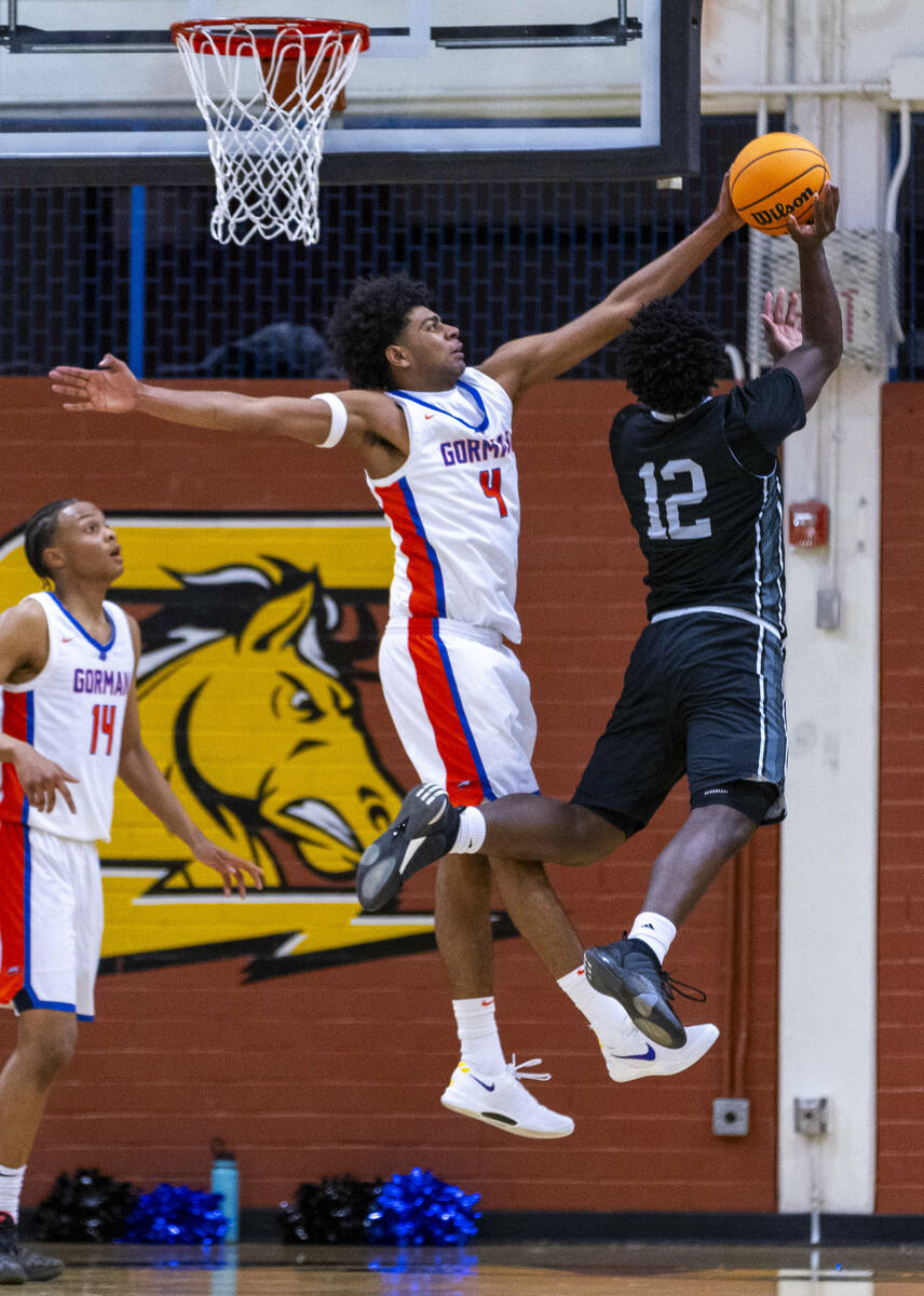 Bishop Gorman's forward Trey McKinney (4) blocks a shot attempt by Desert Pines forward Mike Ta ...