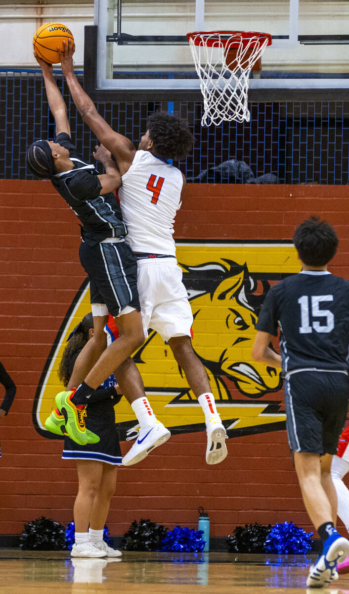 Desert Pines guard Jaden Redding (1) has a shot attempt blocked by Bishop Gorman's forward Trey ...