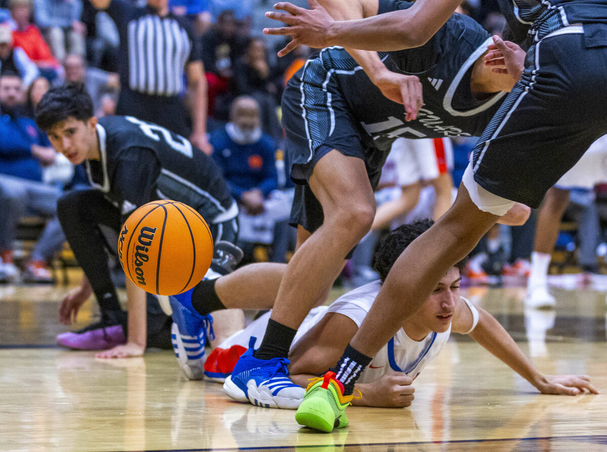 Bishop Gorman guard Dino Roberts (5) loses the ball against Desert Pines during the second half ...