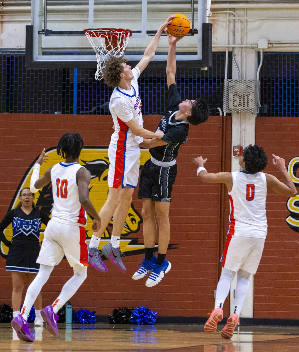 Bishop Gorman center Chris Baudreau (21) rejects shot attempt by Desert Pines guard Mason Roble ...