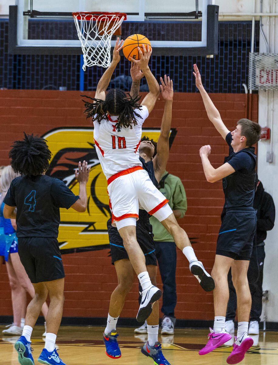 Mojave forward Isaiah Trotter (10) elevates to shoot over Silverado forward Travis Fralin (13) ...