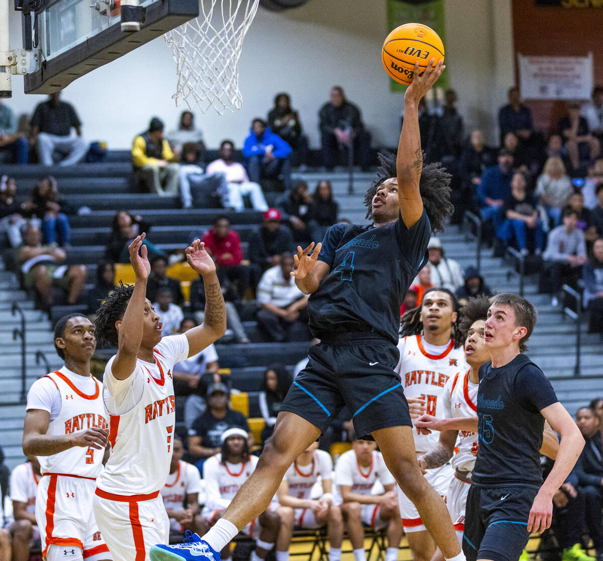 Silverado guard Jaden Charles (4) elevates to shoot over Mojave guard C.J. Shaw (3) during the ...