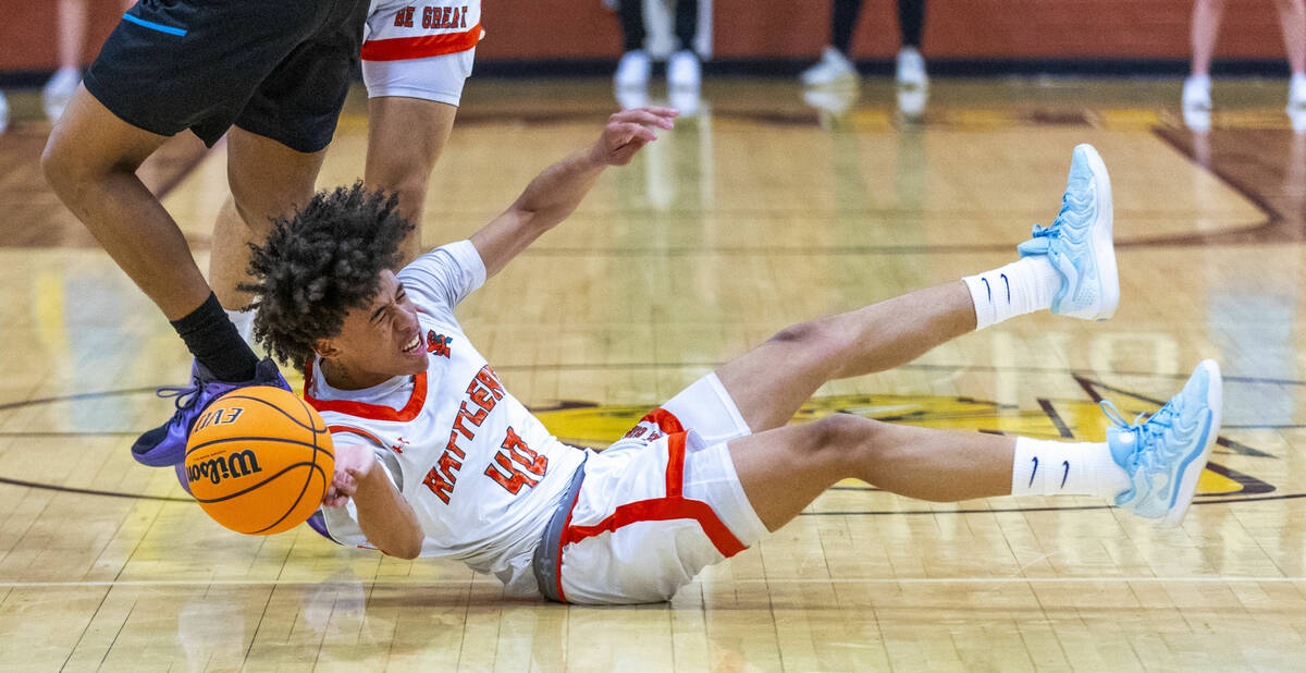 Mojave guard Jordan Lewis (40) loses the ball after fouled by Silverado guard TraVaughn Jensen ...