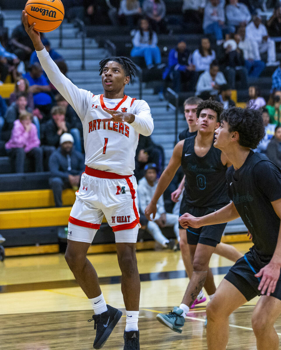 Mojave guard Zacarrion Jackson (1) lays in a basket as Silverado guard Denali Connolly (1) look ...